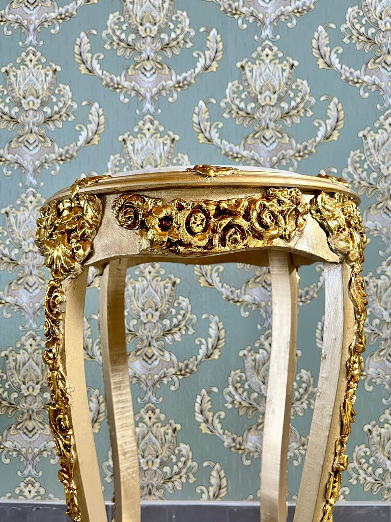 Small gold end table with beige marble top and hand-carved gilded details, elegant side furniture piece.
