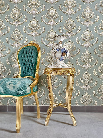 Small gold end table with beige marble top and hand-carved gilded details, perfect for elegant living room decor.