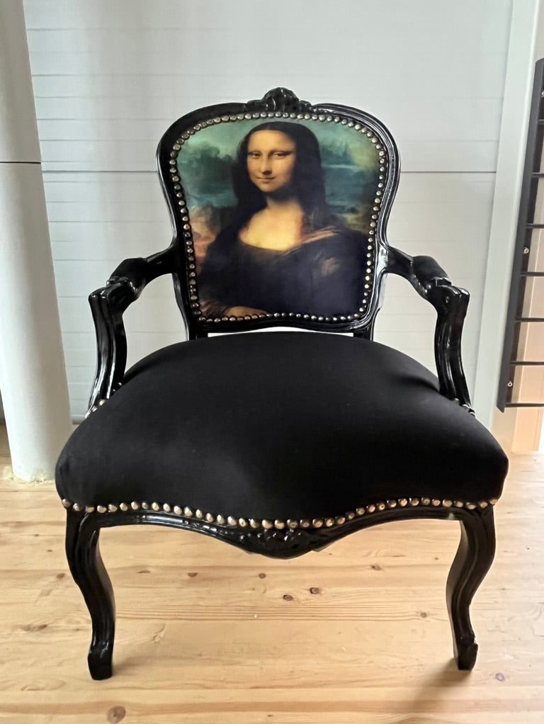 Black Louis XV Baroque armchair by CasAmin Möbel featuring a black and white star portrait design and ornate carved wood details.