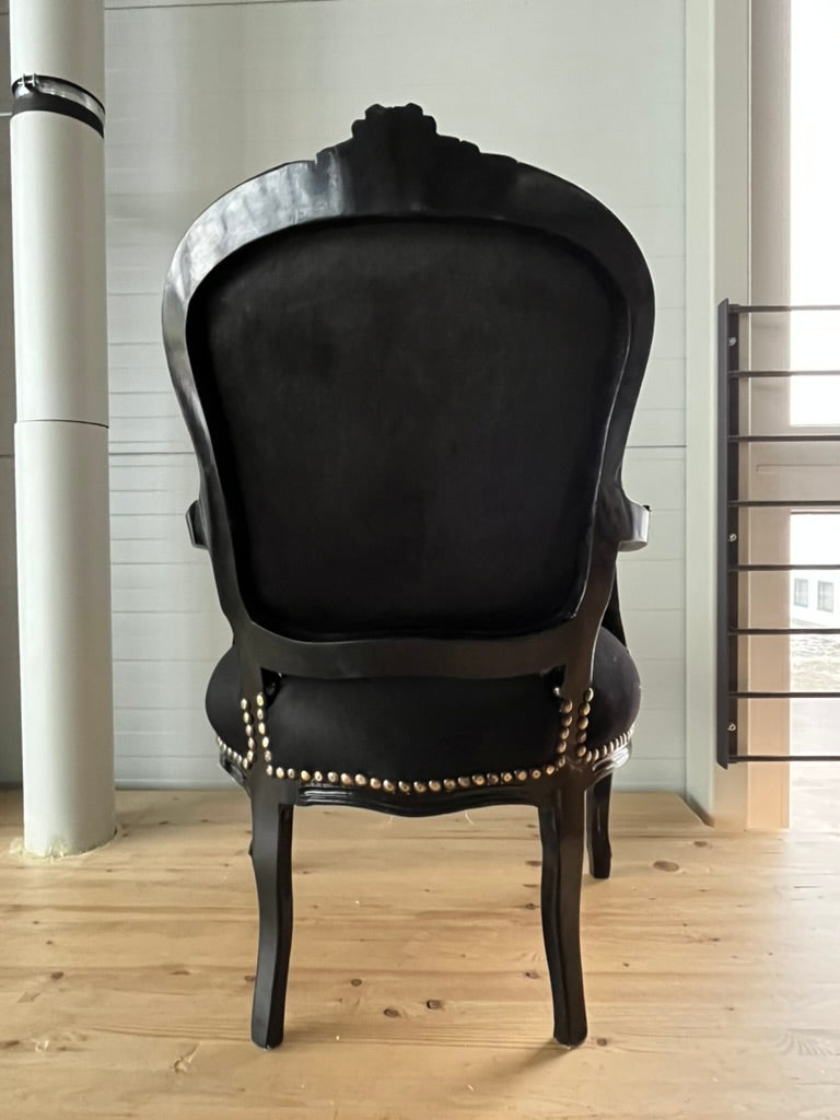 Black Louis XV Baroque armchair by CasAmin Möbel with star portrait design, showcasing ornate black and white furniture style.