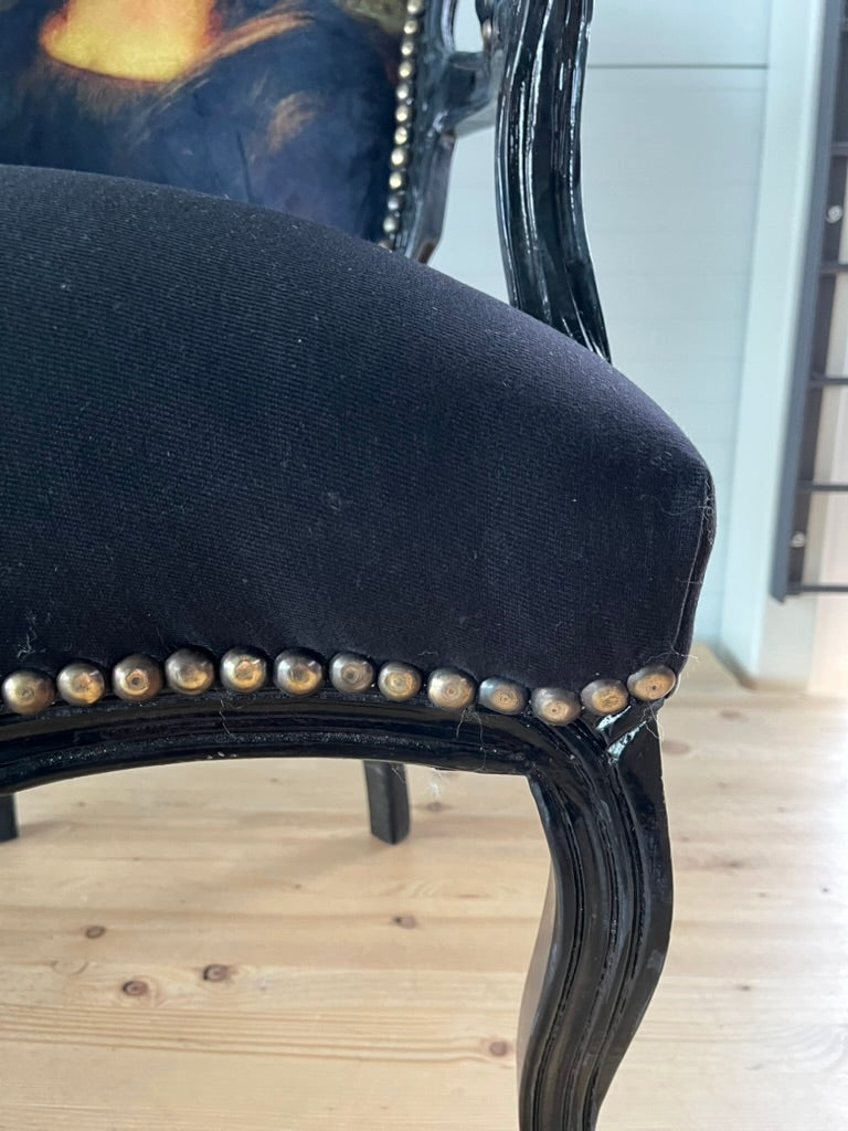 Black Louis XV Baroque armchair by CasAmin Möbel featuring a black and white star portrait design and ornate wooden details.