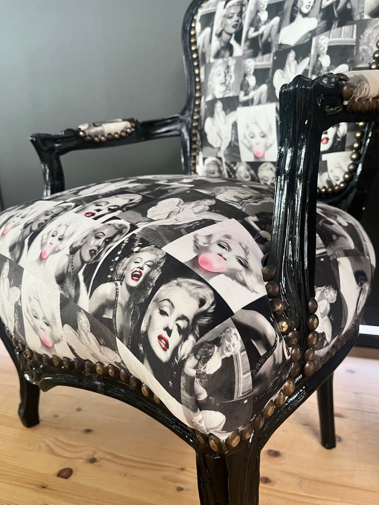 Black Louis XV Baroque armchair by CasAmin Möbel featuring a black and white star portrait design and ornate wooden frame.